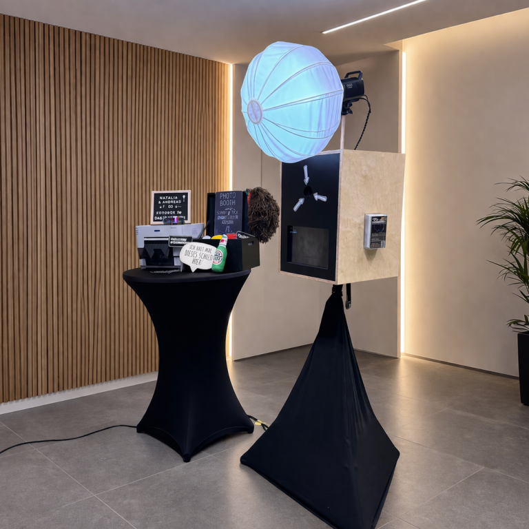 fotobox mit drucker geburtstag ein stilvoller fotostand mit lichtern und verschiedenen kameraausrüstungen.