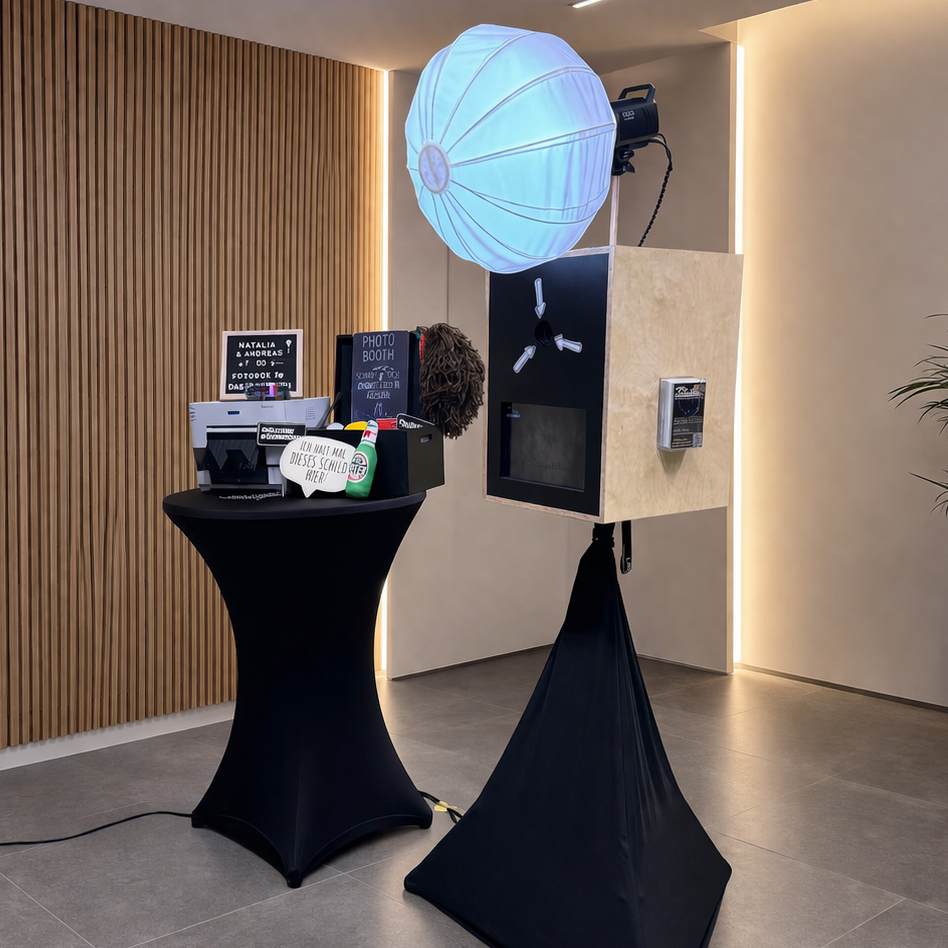 fotobox mit beleuchtung und zubehör fotobox mit beleuchtung und zubehör auf einem stehtisch vor einer modernen wand.